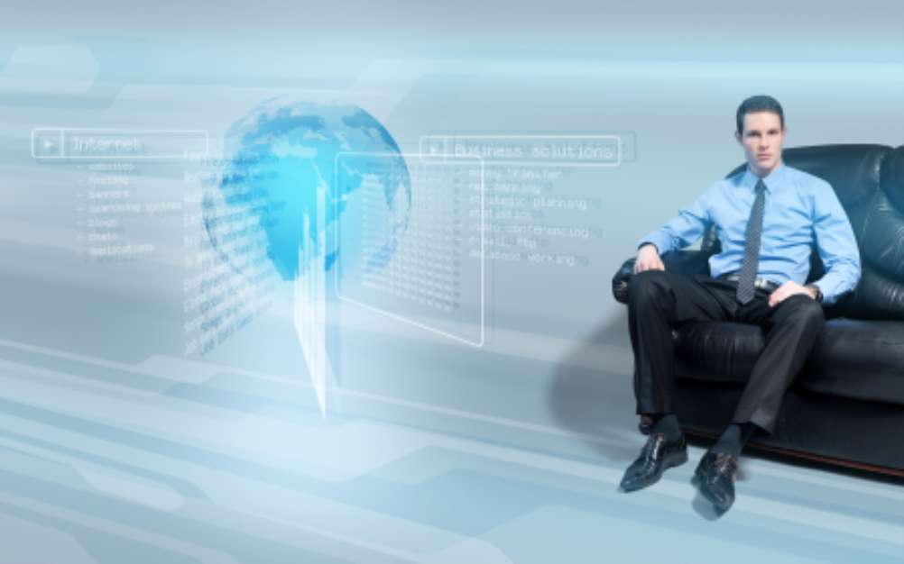 Businessman on the sofa analyzing data from hologram interface