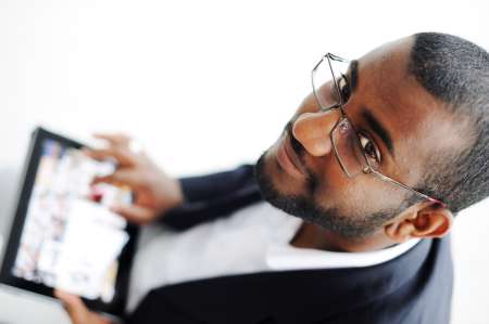 Handsome African American man with tablet computer
