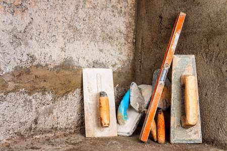 Dirty masonry tools on an unfinished construction