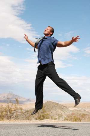 Ecstatic businessman jumping in the air