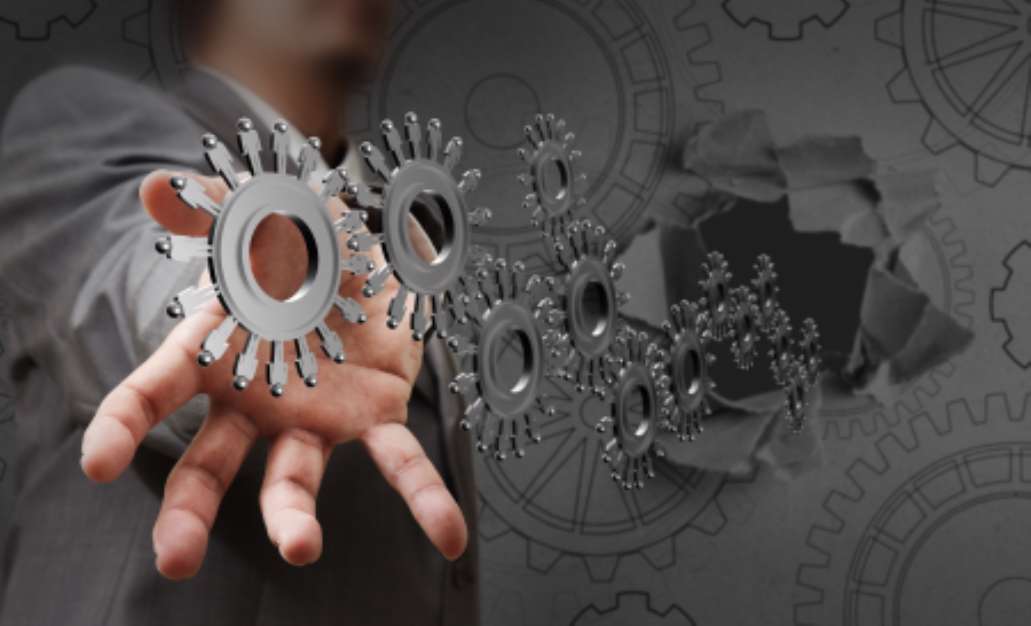 businessman hand shows people cogs