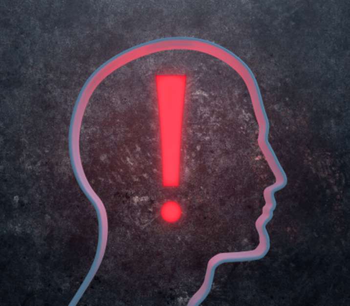 3D silhouette of a male face with a glowing exclamation mark