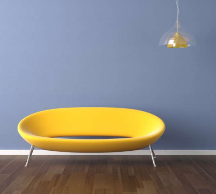 blue wall with yellow couch interior design