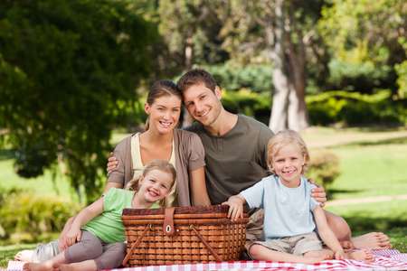 Joyful family picnicking in the park