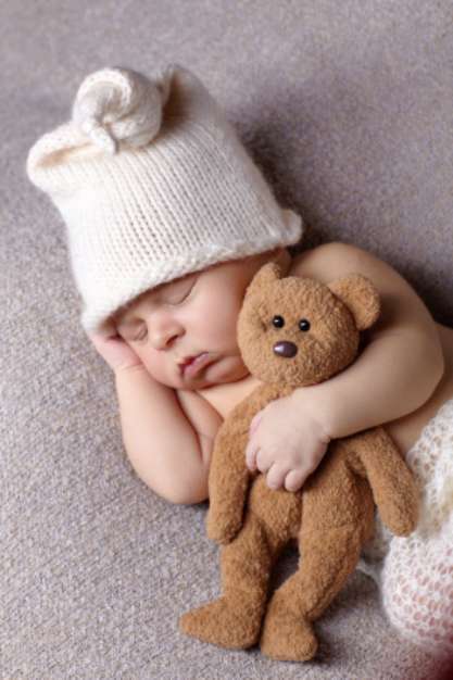 sleeping baby with teddy bear