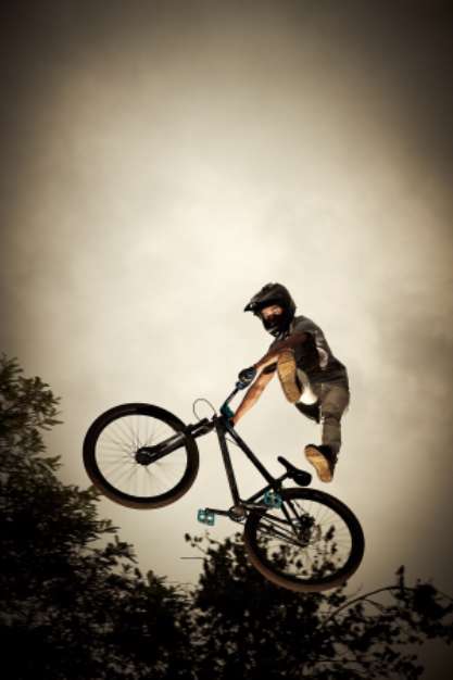 Young man flying on his bike: Dirt jump