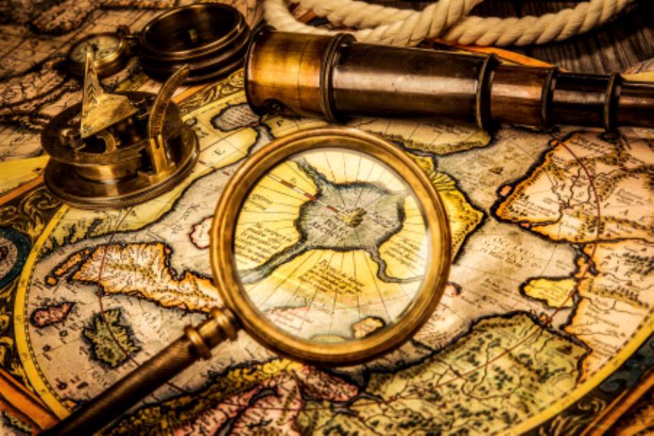 Vintage magnifying glass lies on the ancient map of the North Po