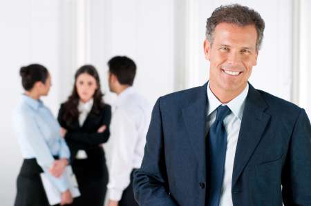 Happy smiling business man with colleagues