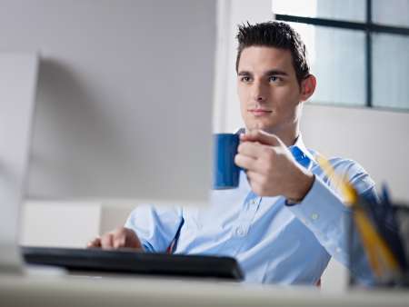 businessman drinking coffee in office