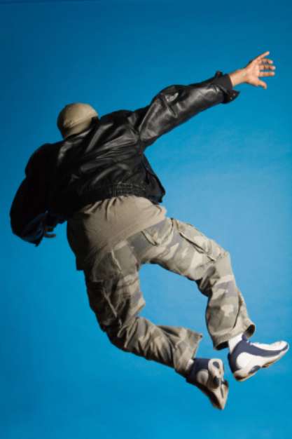 Man in leather jacket jumping