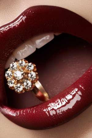 Macro lips cherry make-up with wedding gold diamond ring