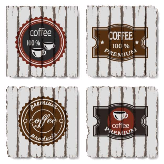 Four coffee labels on old wood background