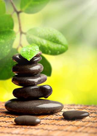 spa green background. stones with water drops