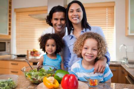 Family preparing salad together