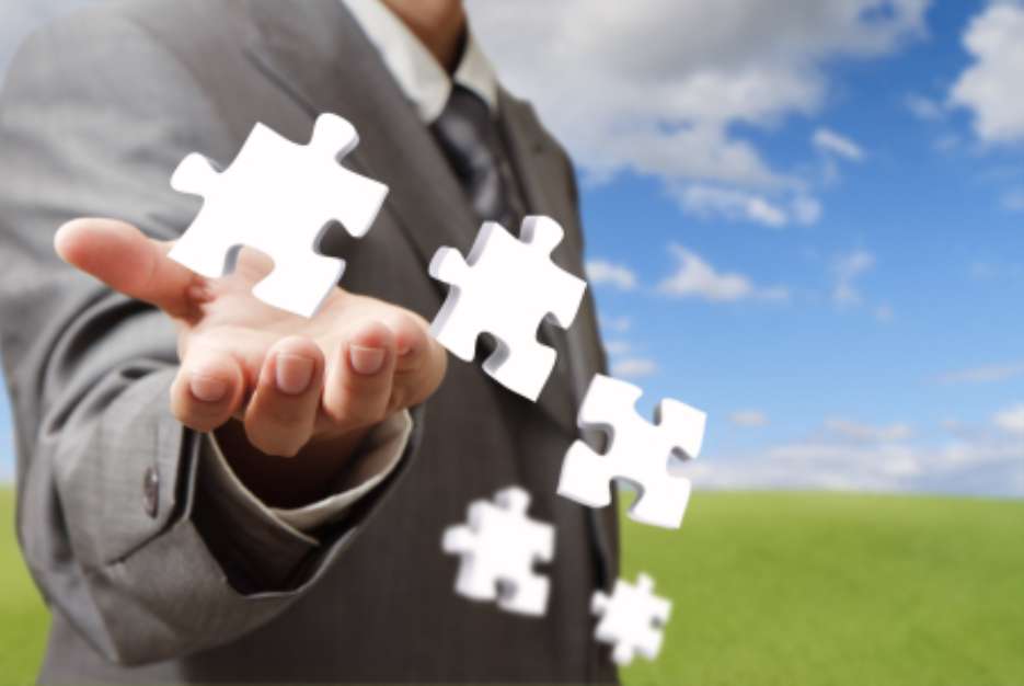businessman hand and business puzzles as concept