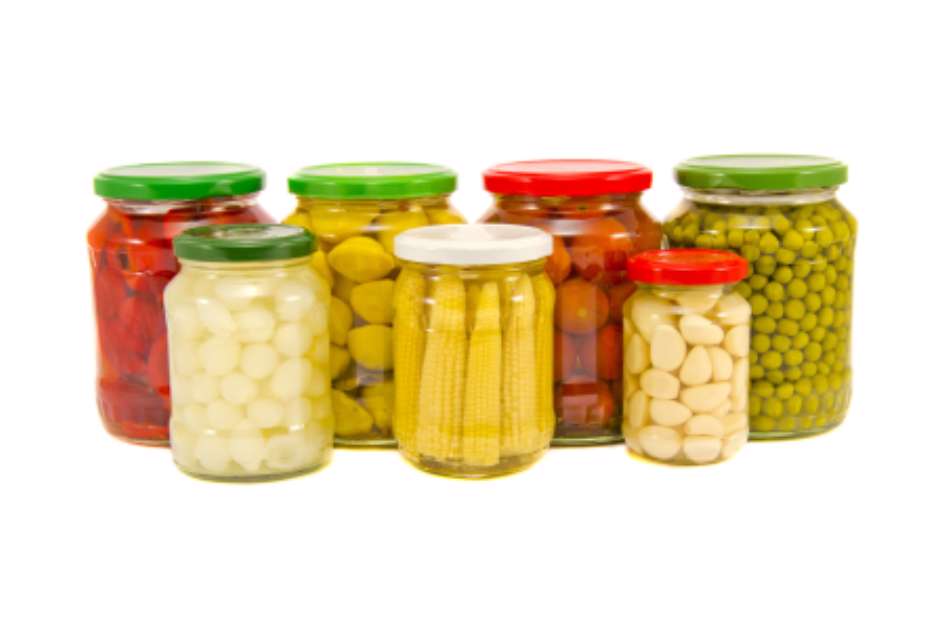 various potted vegetables glass jars isolated on white