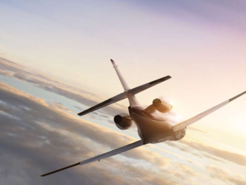 Jet plane at fly to the sunset
