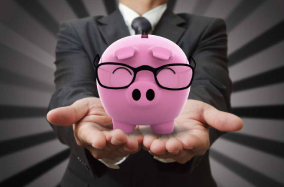 Businessman shows a piggy bank