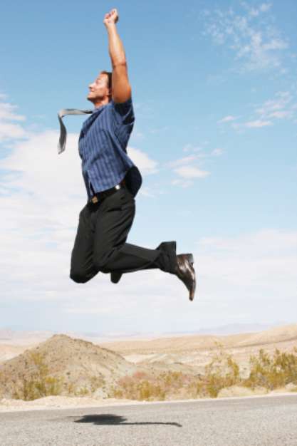 ecstatic young businessman jumping