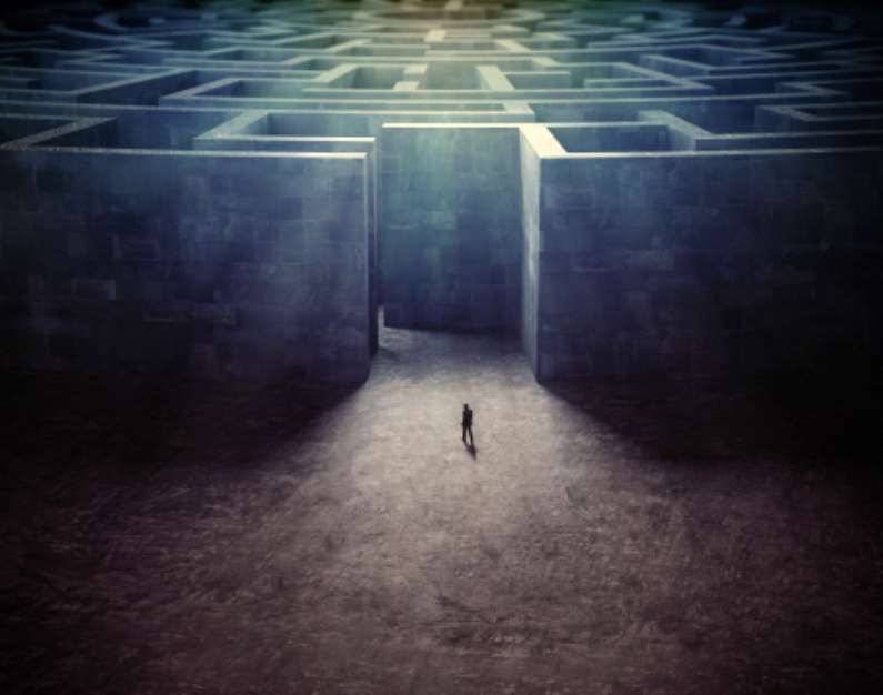 Tiny man entering a mze