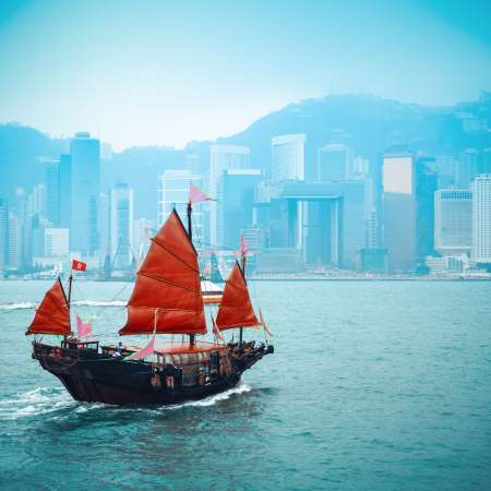 traditional wooden sailboat sailing in victoria harbor