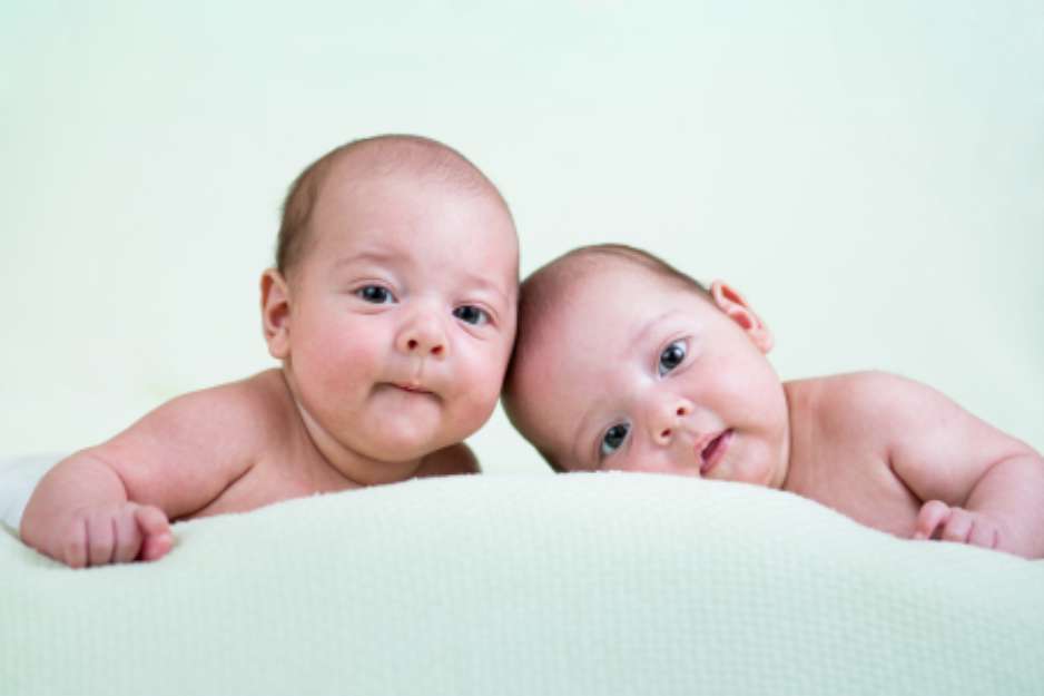 funny newborn baby twins lying on stomach