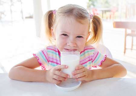 child with a glass of milk