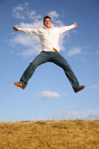 man jumps on meadow
