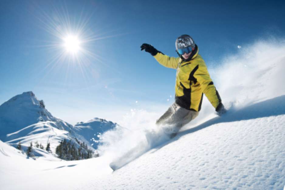 Young snowboarder in deep powder - extreme freeride