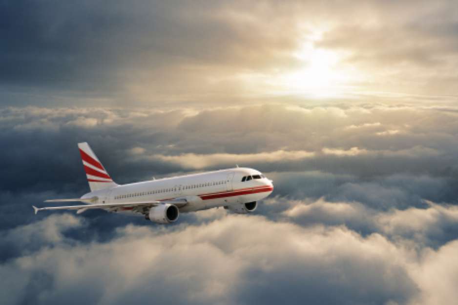 Airplane in the sky at sunset