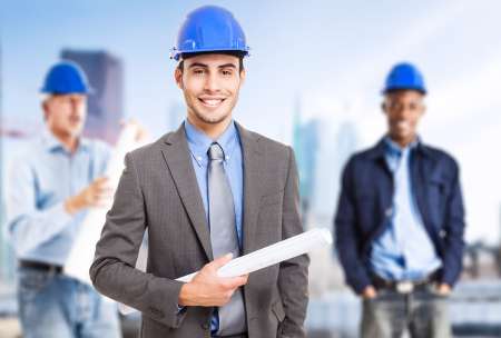 Smiling architect in front of his team