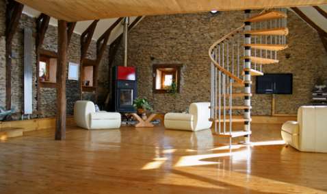 stair case coming down into the living room with fireplace and television