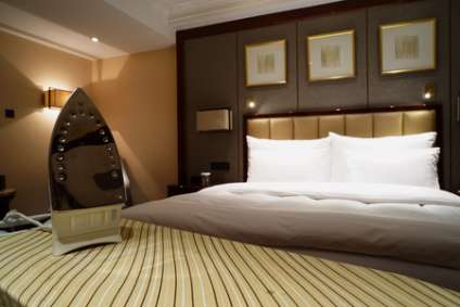Smoothing-iron on an ironing board in hotel room