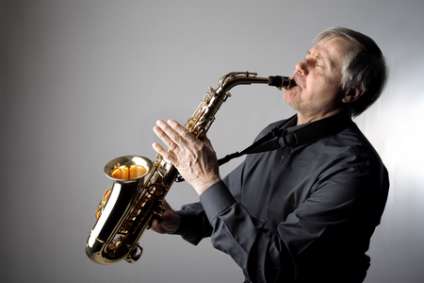 senior man playing the saxophone