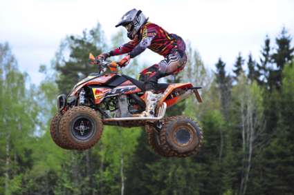 PLUNGE,LITHUANIA-MAY 11:Unidentified rider in flight in Lithuanian Open Motocross Championship 2012 first round on May 11,2012 in Plunge, Lithuania.