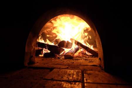 A beautiful wood fired oven with focus on fire.