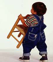 child carrying a chair